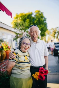 Happy aged couples holding each other closely and smiling